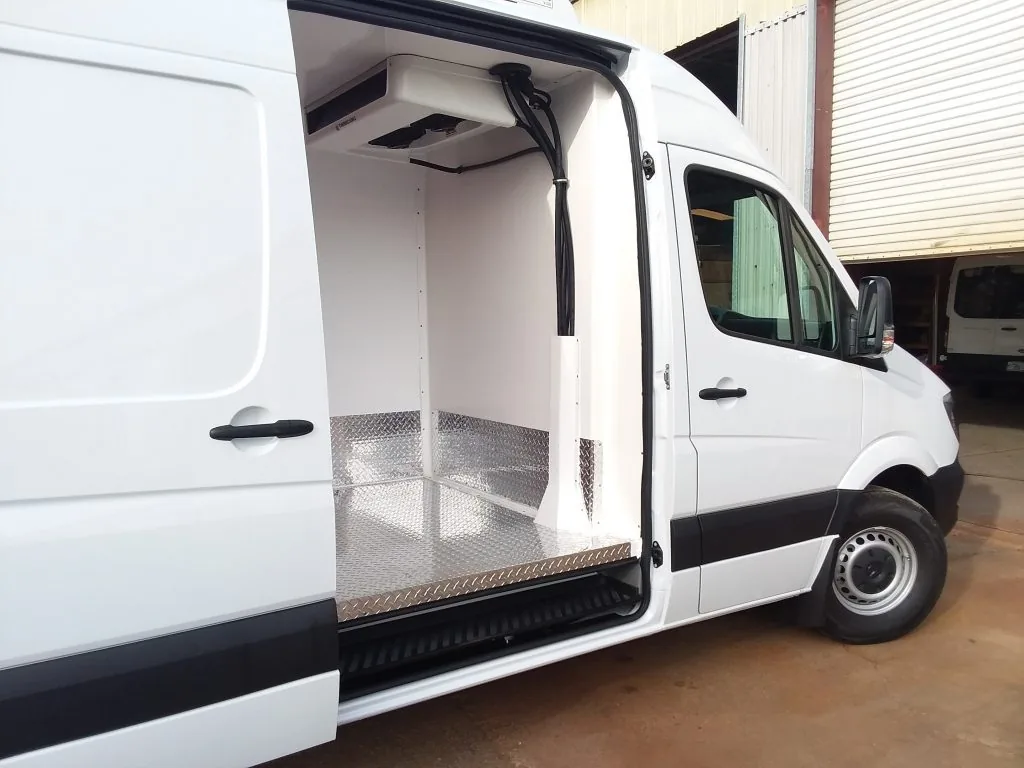 Insulated cargo van interior with transport refrigeration evaporator and diamond plate floor